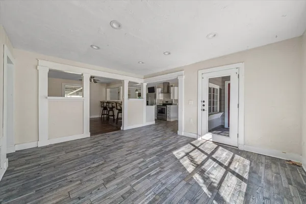 a view of a livingroom with wooden floor and furniture