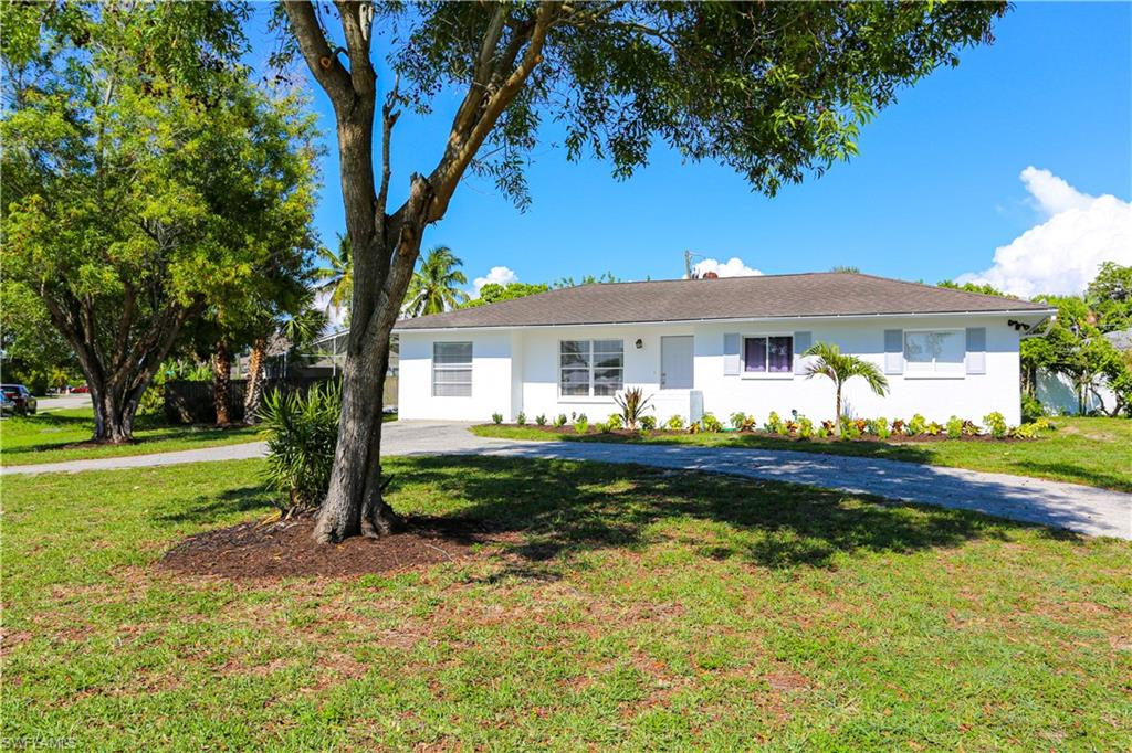 5140 20th Court Southwest Naples, FL 34116 - Photo 1 of 33 a front view of a house with swimming pool having outdoor seating