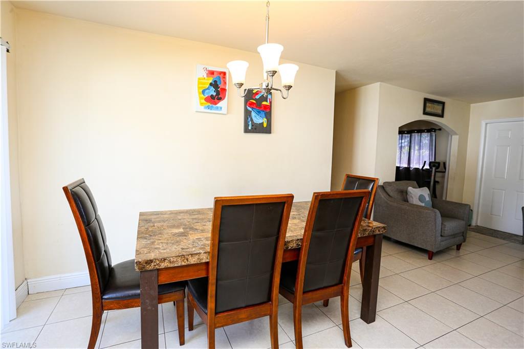 5140 20th Court Southwest Naples, FL 34116 - Photo 13 of 33 a view of a dining room with furniture and a chandelier