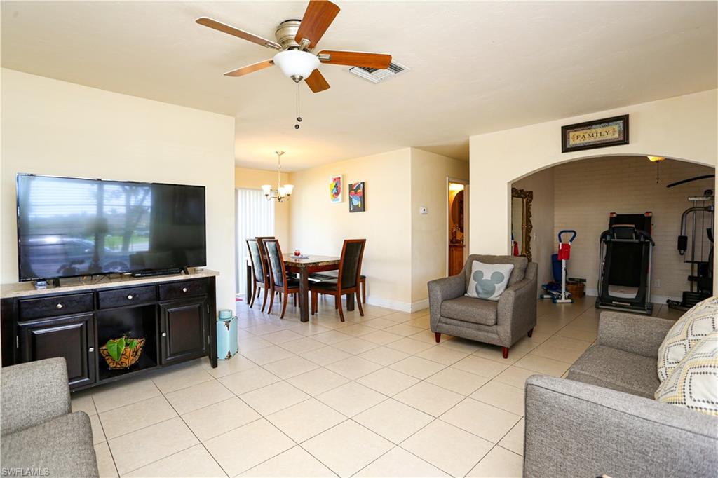 5140 20th Court Southwest Naples, FL 34116 - Photo 16 of 33 a living room with furniture and a flat screen tv