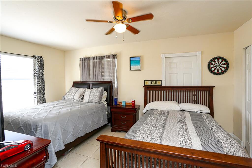 5140 20th Court Southwest Naples, FL 34116 - Photo 18 of 33 a bedroom with bed and window