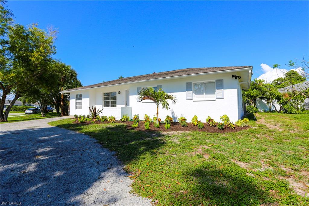 5140 20th Court Southwest Naples, FL 34116 - Photo 2 of 33 a front view of house with yard and green space