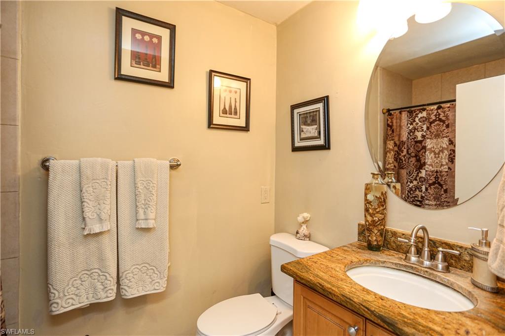 5140 20th Court Southwest Naples, FL 34116 - Photo 21 of 33 a bathroom with a granite countertop sink mirror and toilet