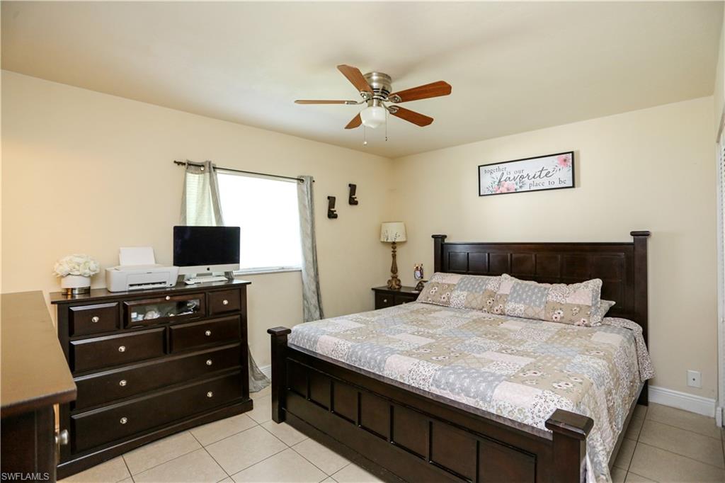 5140 20th Court Southwest Naples, FL 34116 - Photo 22 of 33 a bedroom with a bed and a flat screen tv