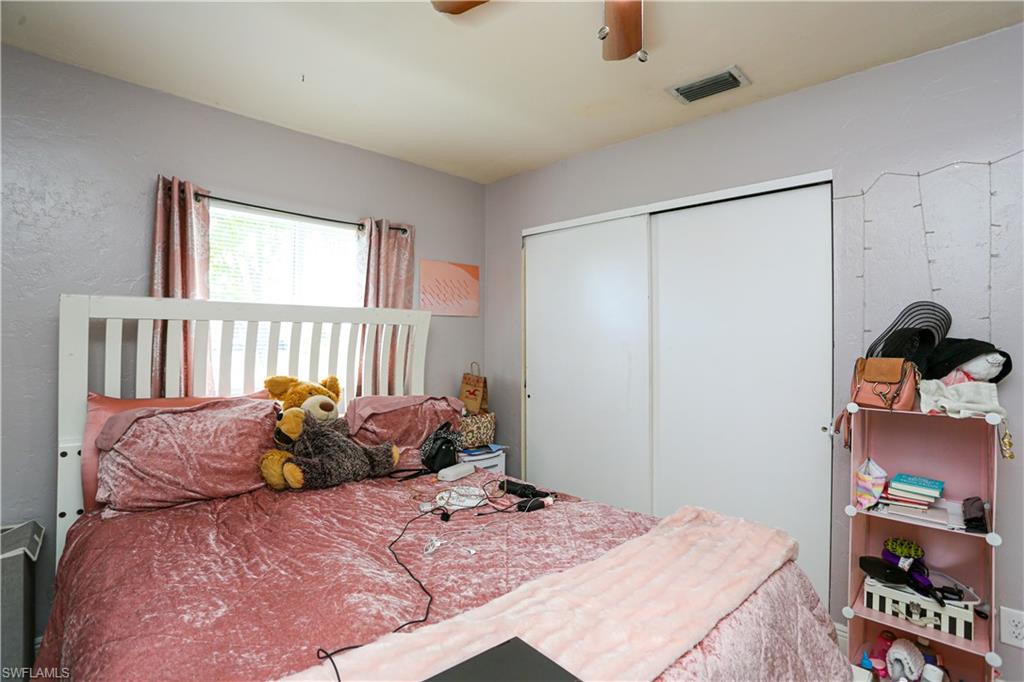 5140 20th Court Southwest Naples, FL 34116 - Photo 26 of 33 a bed sitting in a bedroom next to a window
