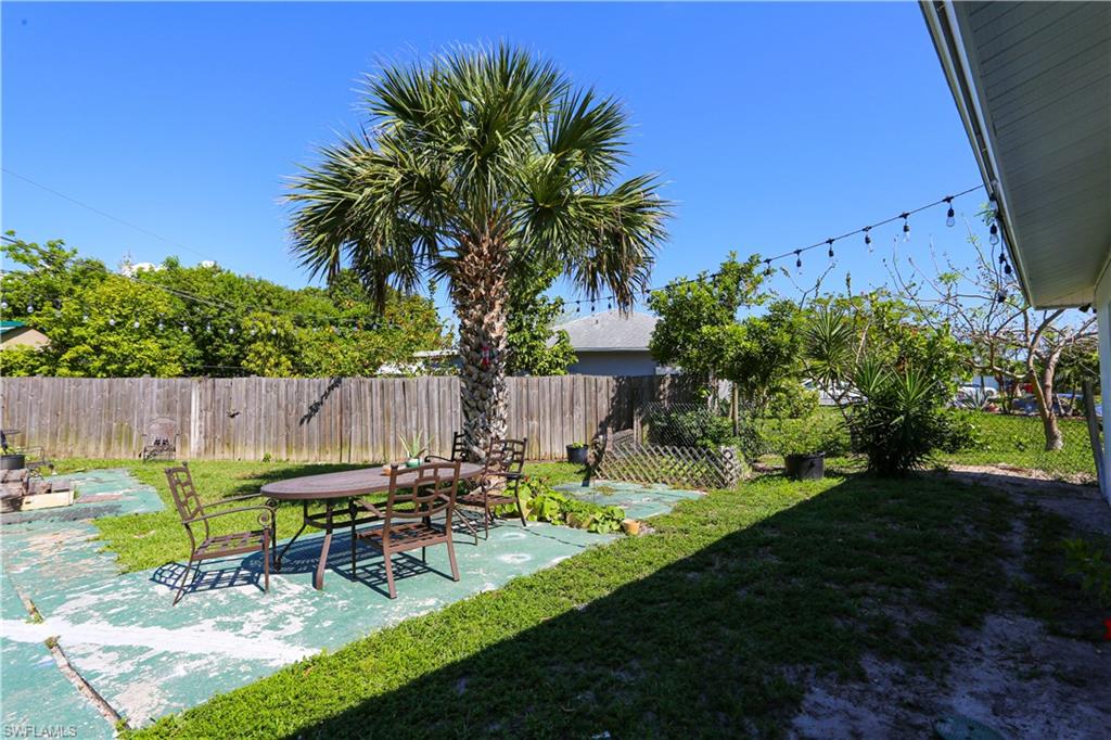 5140 20th Court Southwest Naples, FL 34116 - Photo 29 of 33 a view of a chair and table in backyard of the house