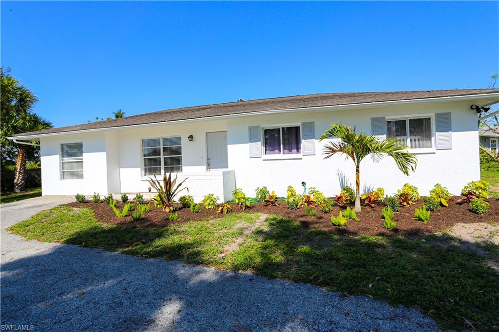 5140 20th Court Southwest Naples, FL 34116 - Photo 5 of 33 a front view of a house with garden