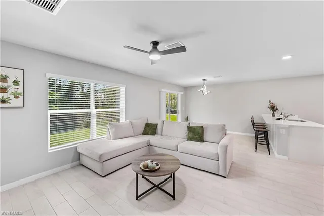 a living room with furniture and a large window