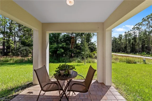 a view of a two chairs in the patio