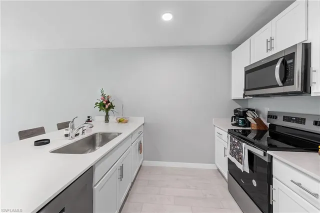 a kitchen with stainless steel appliances granite countertop a sink and stove top oven