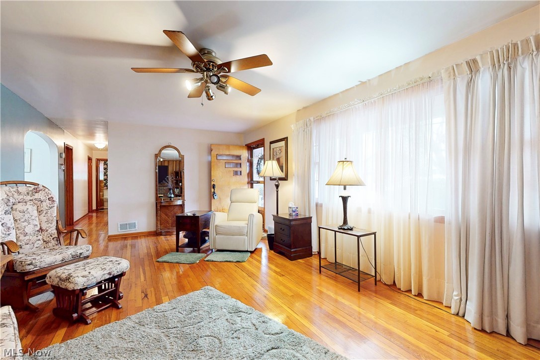 391 Canton Road Steubenville, OH 43953 - Photo 5 of 40 Sitting room featuring light wood finished floors, a ceiling fan, and arched walkways