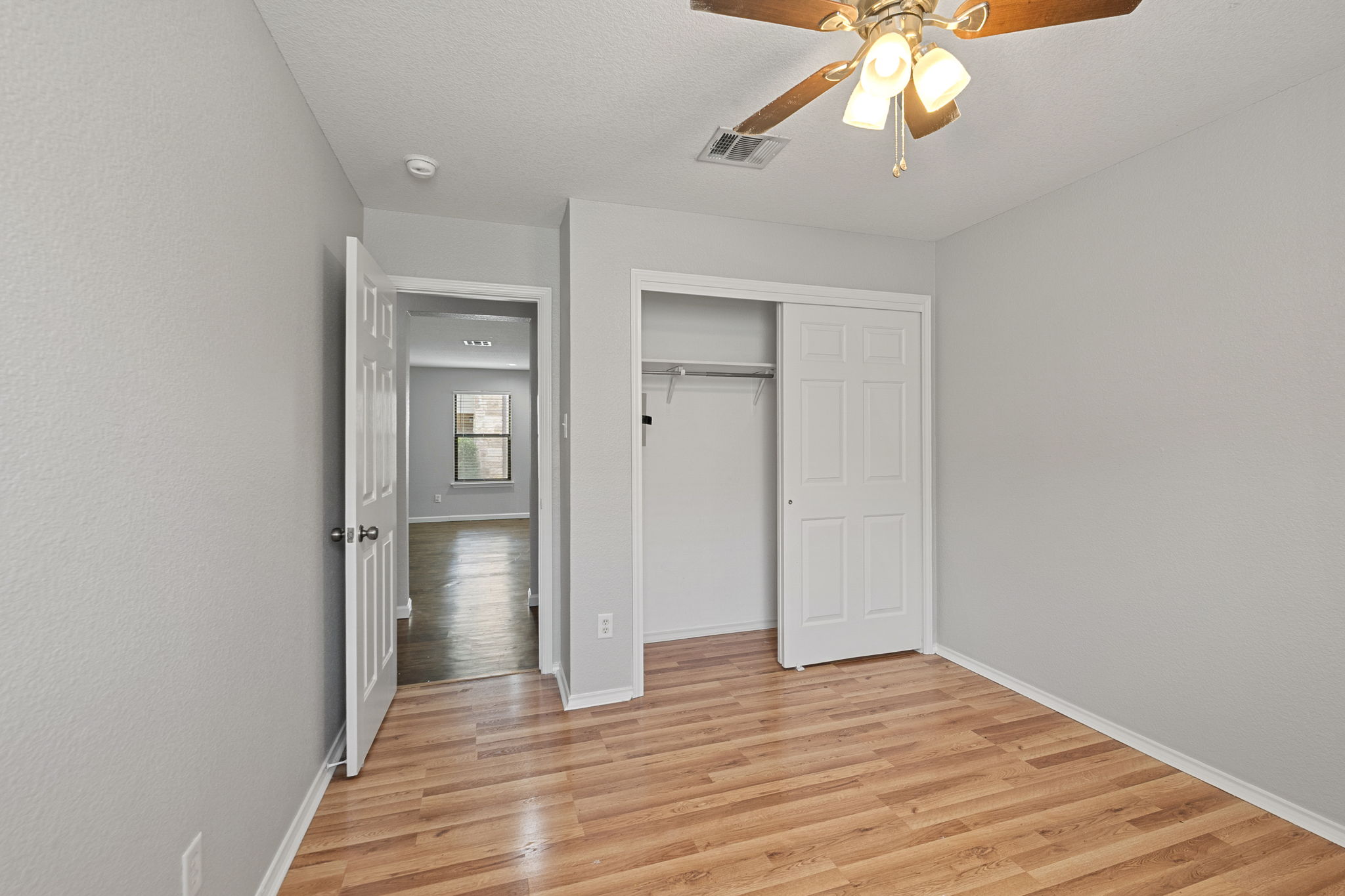 4209 Glacier Point Cove Taylor, TX 76574 - Photo 22 of 36 a view of a room with wooden floor and a ceiling fan