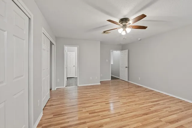 a view of an empty room with wooden floor