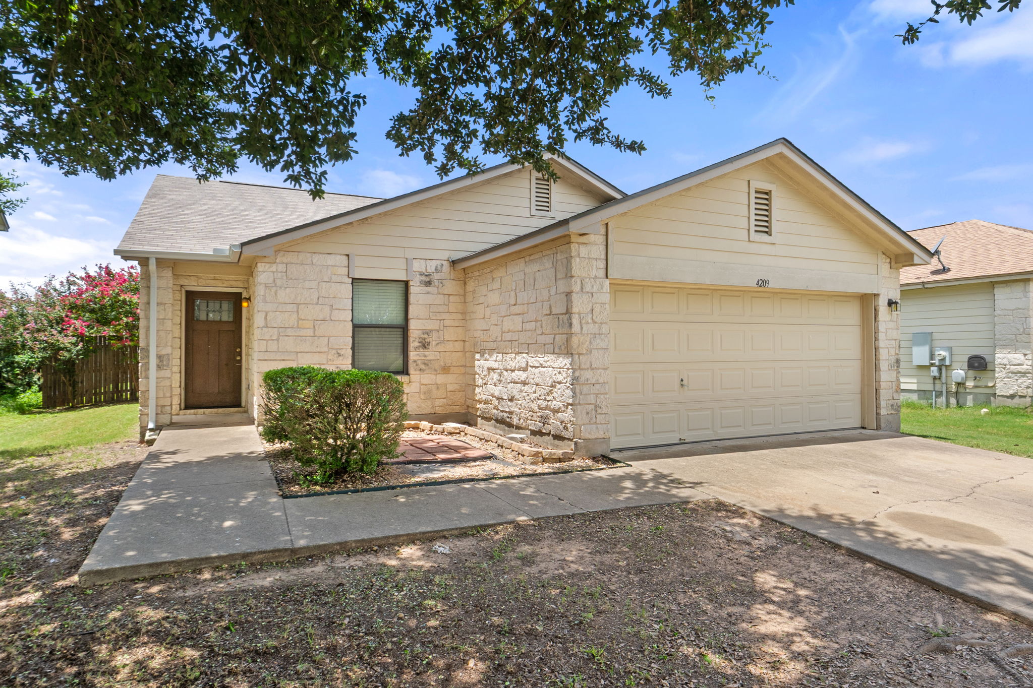 4209 Glacier Point Cove Taylor, TX 76574 - Photo 3 of 36 a front view of a house with a yard and garage