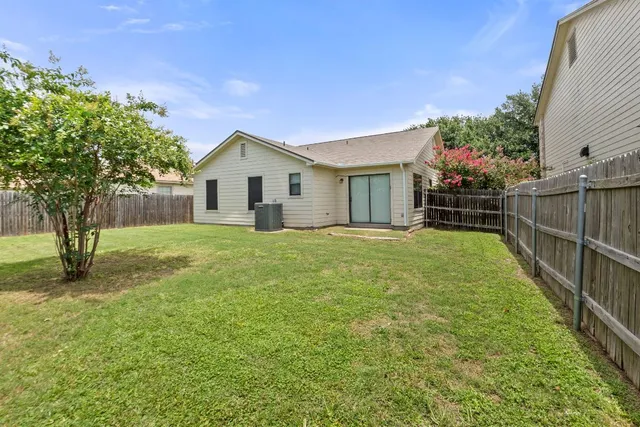 a view of a backyard with a tree