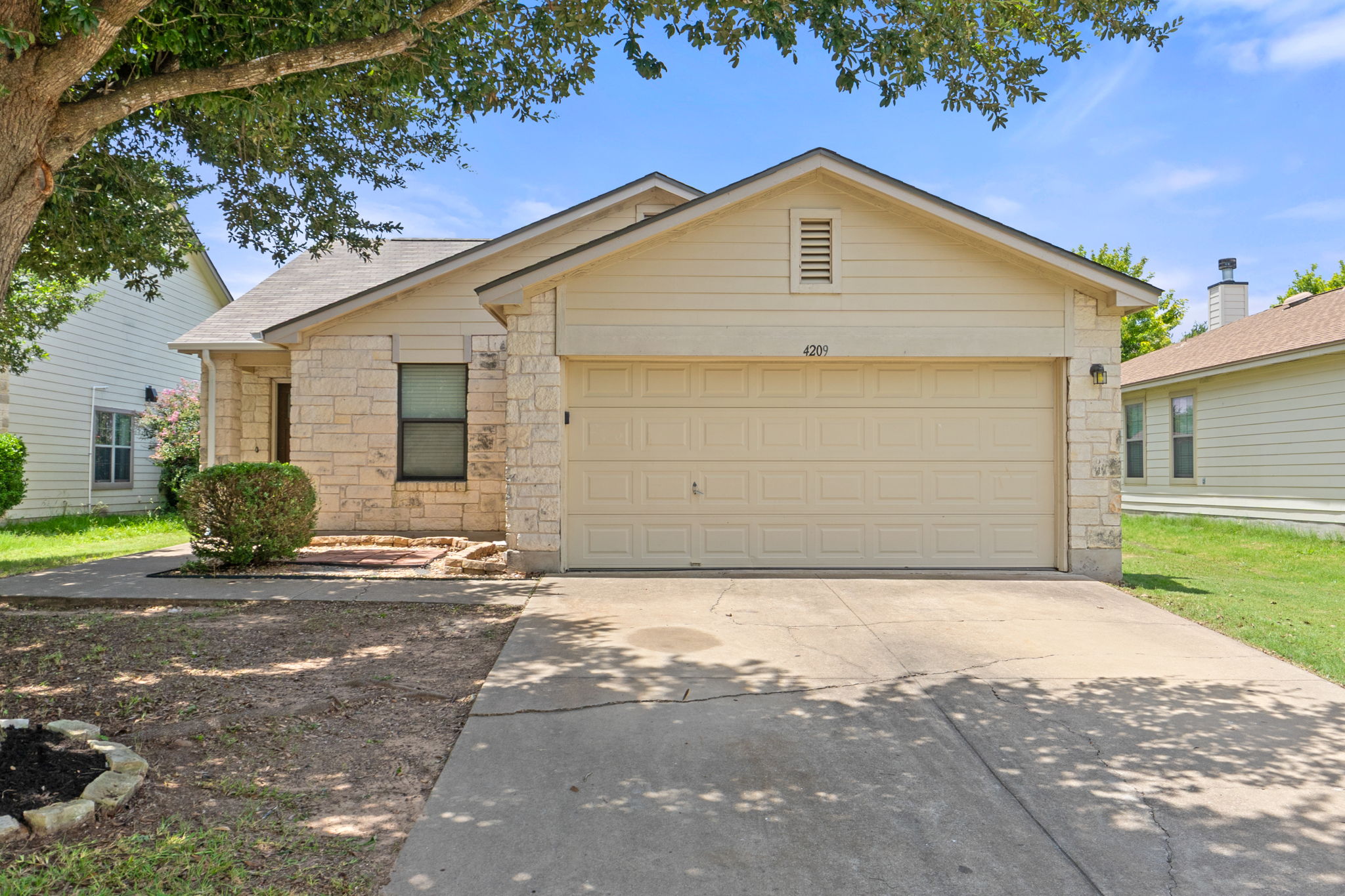 4209 Glacier Point Cove Taylor, TX 76574 - Photo 4 of 36 a front view of a house with a yard and garage