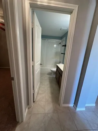 a view of a hallway to rooms