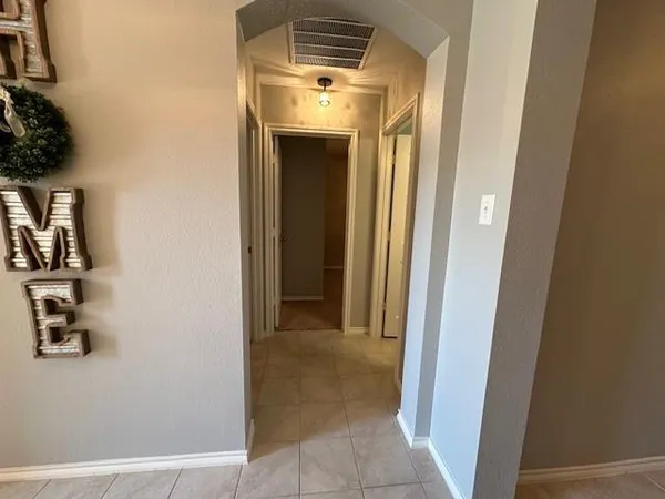a view of a hallway with wooden floor and closet