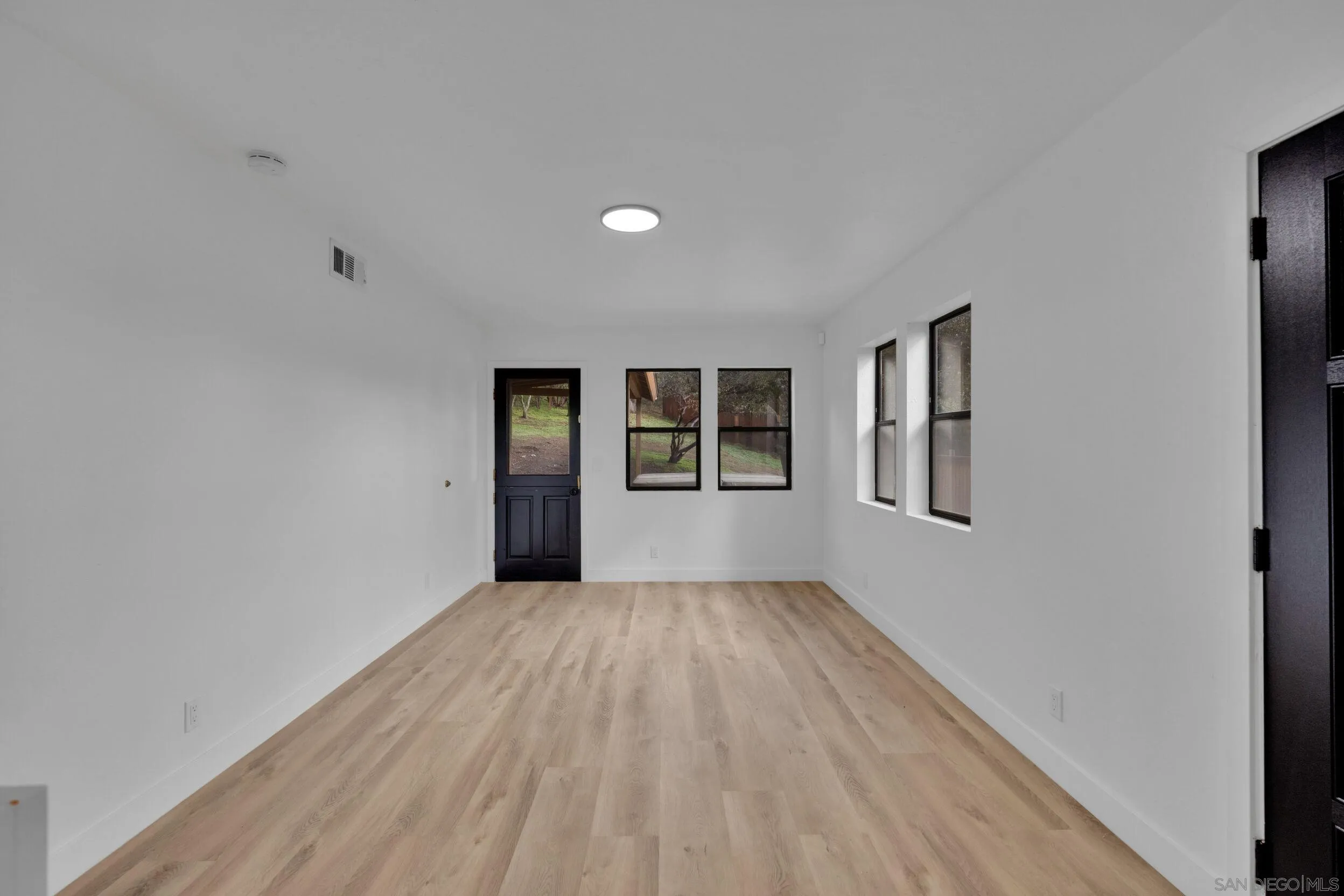 2657 Payson Drive Julian, CA 92036 - Photo 12 of 43 a view of an empty room with a window and wooden floor