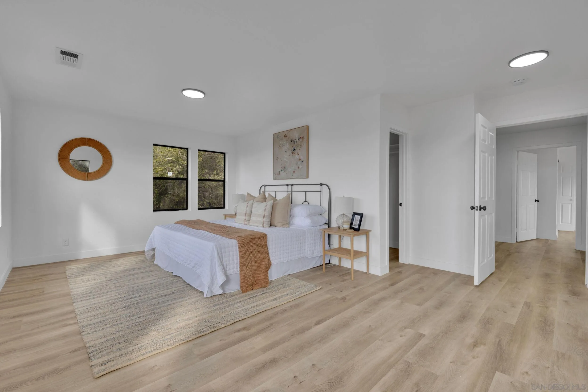 2657 Payson Drive Julian, CA 92036 - Photo 25 of 43 a spacious bedroom with a bed and a lamp