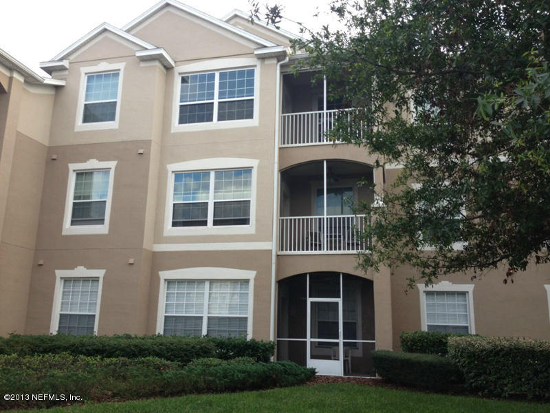 7990 Baymeadows Road East, Unit 426 Jacksonville, FL 32256 - Photo 1 of 14 a front view of a house with a yard