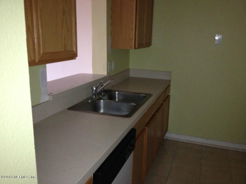 7990 Baymeadows Road East, Unit 426 Jacksonville, FL 32256 - Photo 12 of 14 a kitchen with a sink and cabinets