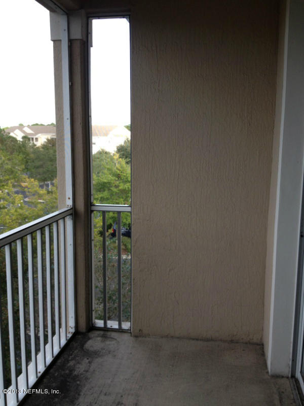 7990 Baymeadows Road East, Unit 426 Jacksonville, FL 32256 - Photo 4 of 14 an empty room with wooden floor