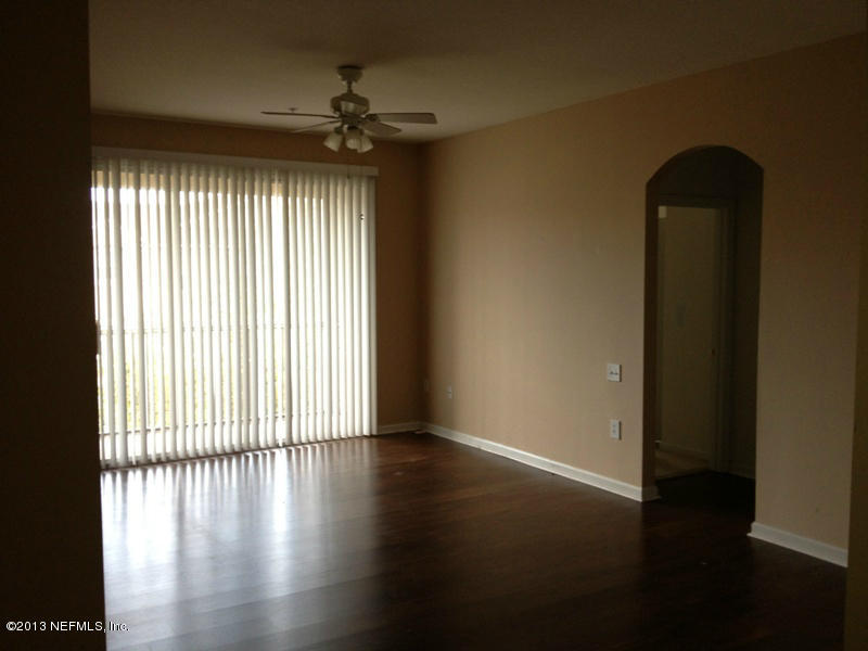 7990 Baymeadows Road East, Unit 426 Jacksonville, FL 32256 - Photo 9 of 14 an empty room with wooden floor and windows