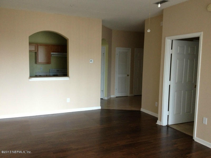 7990 Baymeadows Road East, Unit 426 Jacksonville, FL 32256 - Photo 10 of 14 an empty room with wooden floor and windows