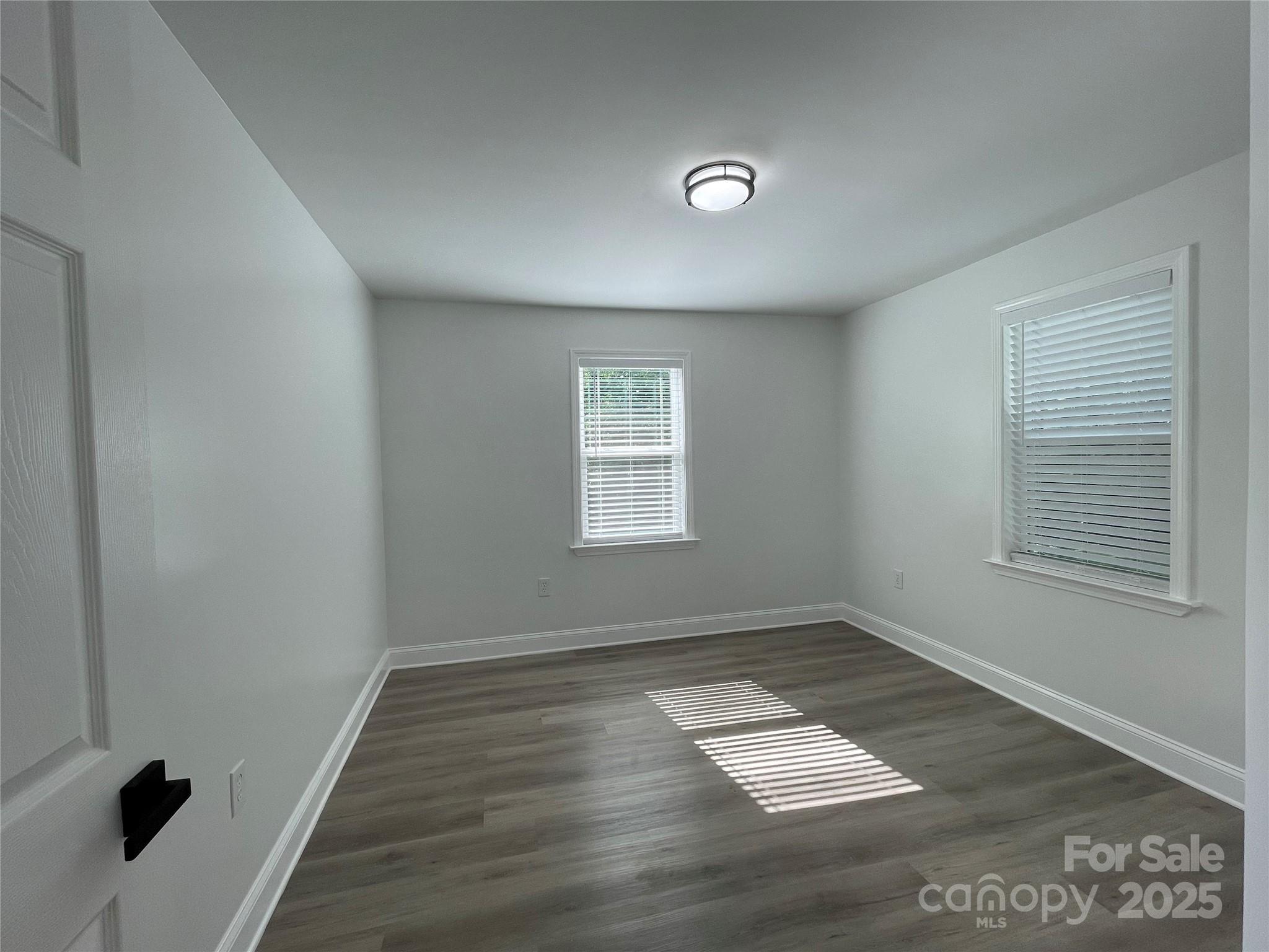 210 River Drive Gaffney, SC 29340 - Photo 14 of 18 an empty room with wooden floor and windows