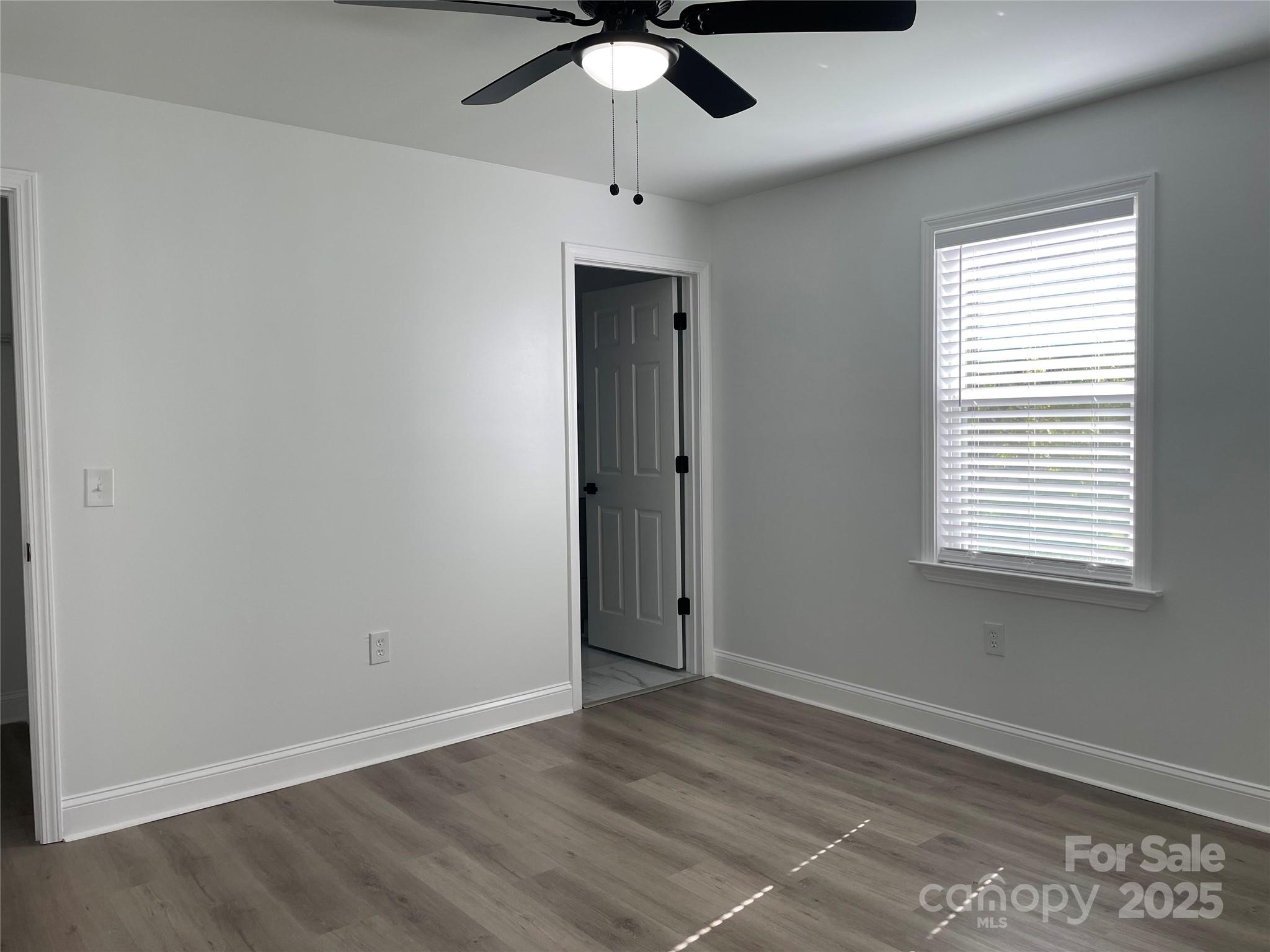 210 River Drive Gaffney, SC 29340 - Photo 9 of 18 an empty room with a window and a fan