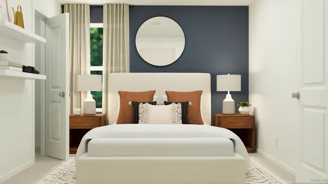 a bedroom with a bed and a mirror