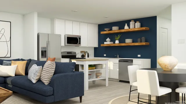 a living room with furniture and a kitchen area