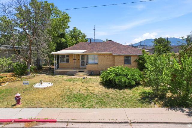 5480 South 2000th Street West Roy, UT 84067 - Photo 7 of 36 Brick exterior with a covered front porch and a gabled roof