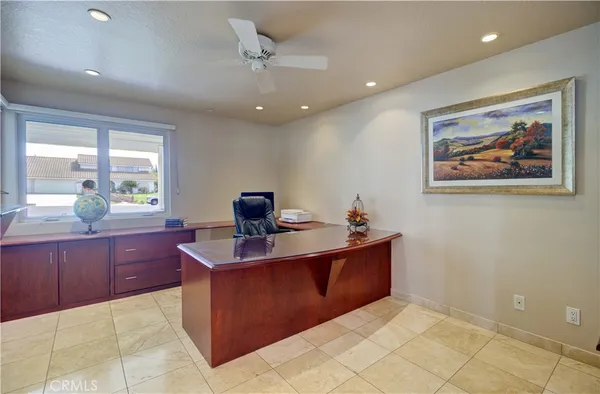 a kitchen with kitchen island granite countertop a sink and a stove top oven