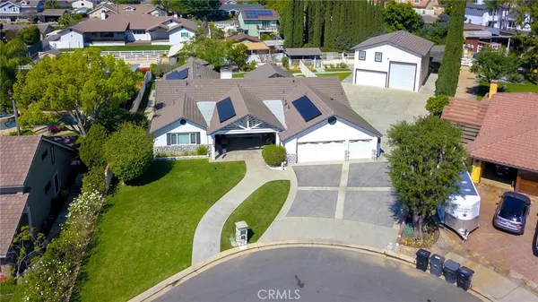 an aerial view of a house with garden space and street view