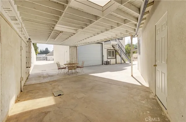 a picture of a book shelf with a white bed