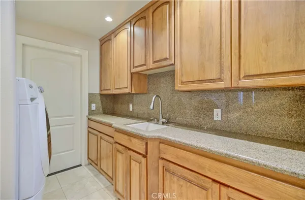 a kitchen with stainless steel appliances granite countertop a sink and a white cabinets
