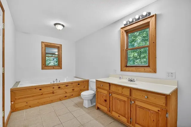 a bathroom with a sink mirror and a bathtub