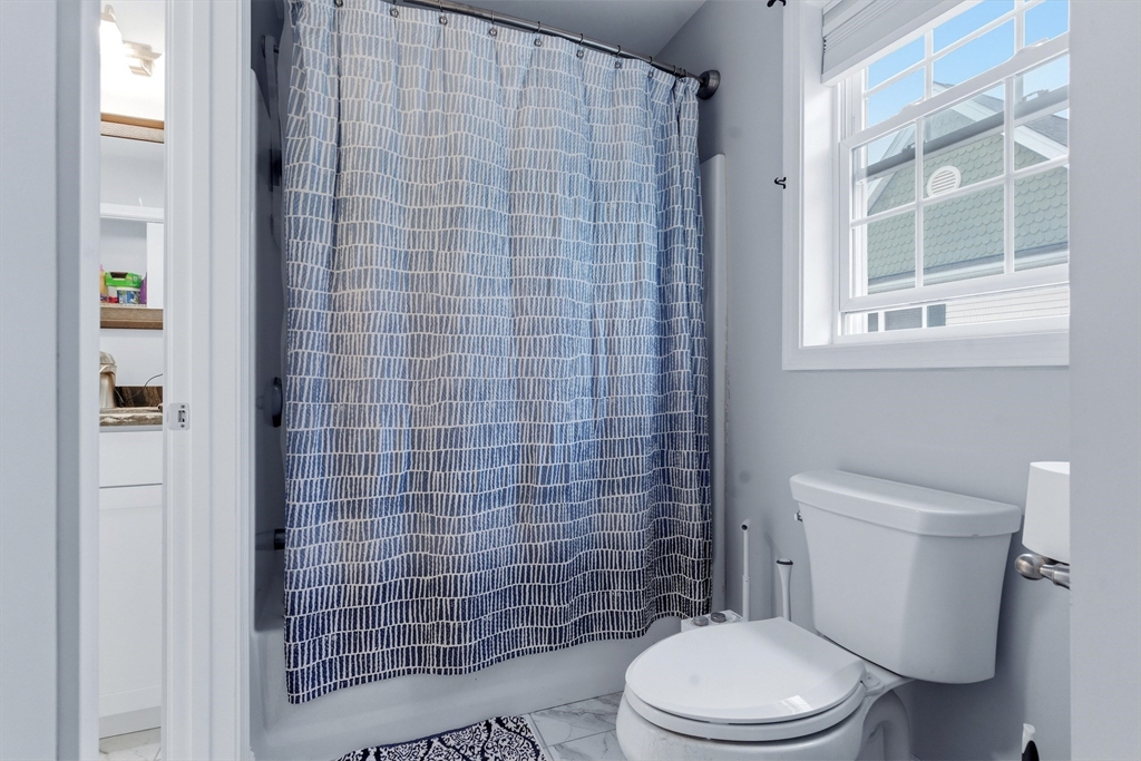 10 North Court Street, Unit 3 Fall River, MA 02720 - Photo 17 of 25 a white toilet sitting next to a bathroom sink and a shower