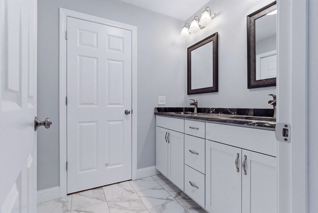 10 North Court Street, Unit 3 Fall River, MA 02720 - Photo 18 of 25 a bathroom with white cabinets and a sink