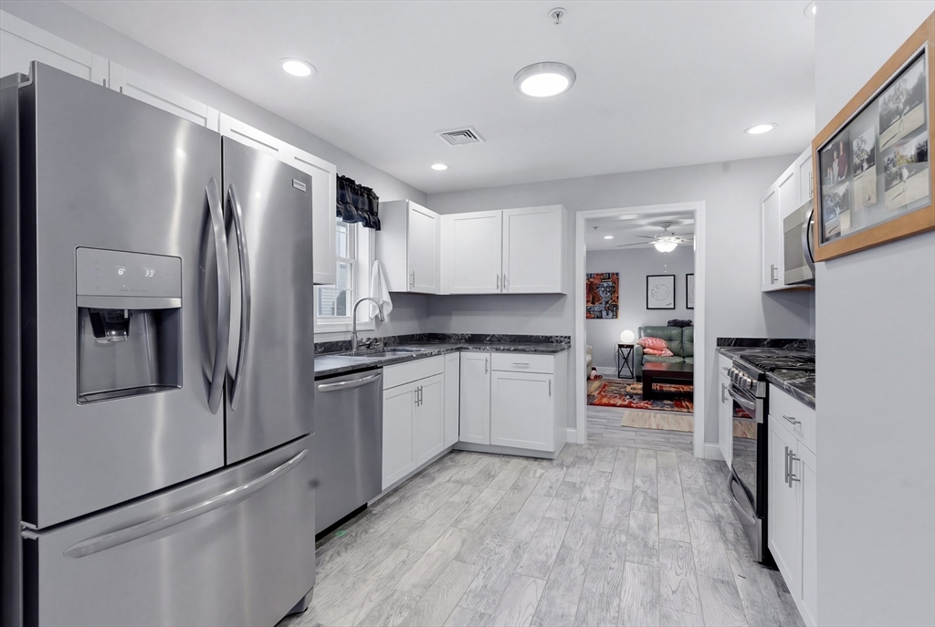 10 North Court Street, Unit 3 Fall River, MA 02720 - Photo 2 of 25 a kitchen with stainless steel appliances granite countertop a refrigerator a stove and a sink