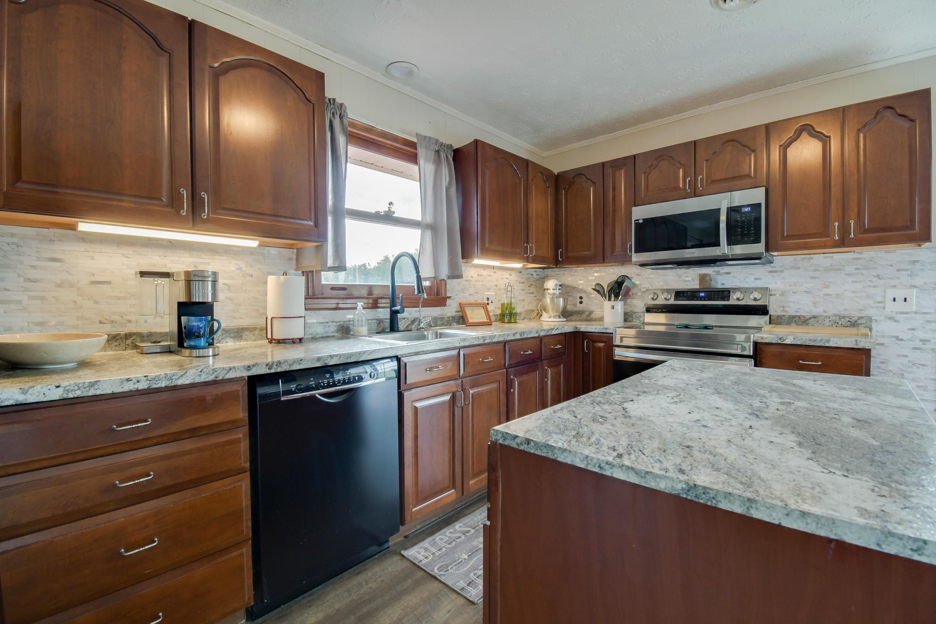 263 Craig Shop Road Mount Sidney, VA 24467 - Photo 2 of 25 a kitchen with granite countertop wooden cabinets and a sink