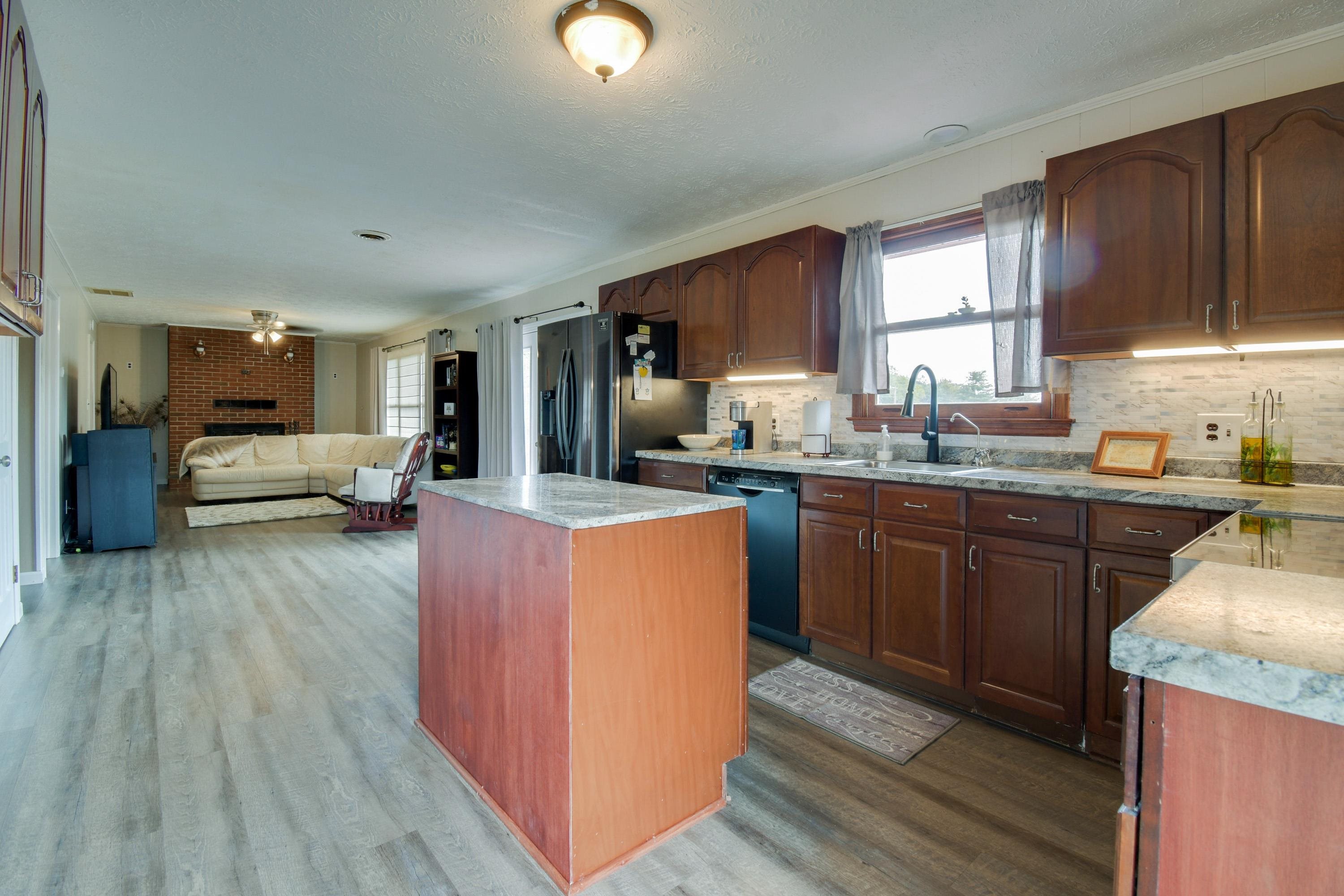 263 Craig Shop Road Mount Sidney, VA 24467 - Photo 5 of 25 a kitchen with kitchen island granite countertop wooden floors wooden cabinets a sink and appliances