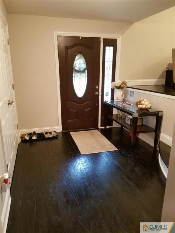 21 Barker Road Somerset, NJ 08873 - Photo 3 of 25 an empty room with wooden floor mirror and windows