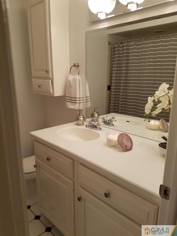 21 Barker Road Somerset, NJ 08873 - Photo 21 of 25 a bathroom with a sink and a mirror