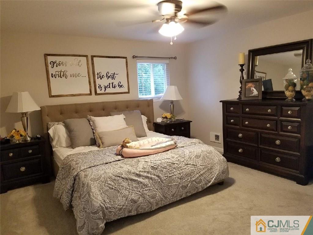21 Barker Road Somerset, NJ 08873 - Photo 23 of 25 a bedroom with a bed and a mirror on dresser
