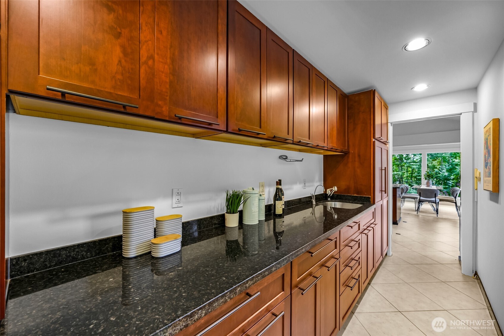 8449 West Mercer Way Mercer Island, WA 98040 - Photo 13 of 40 a kitchen with granite countertop a sink a stove and cabinets