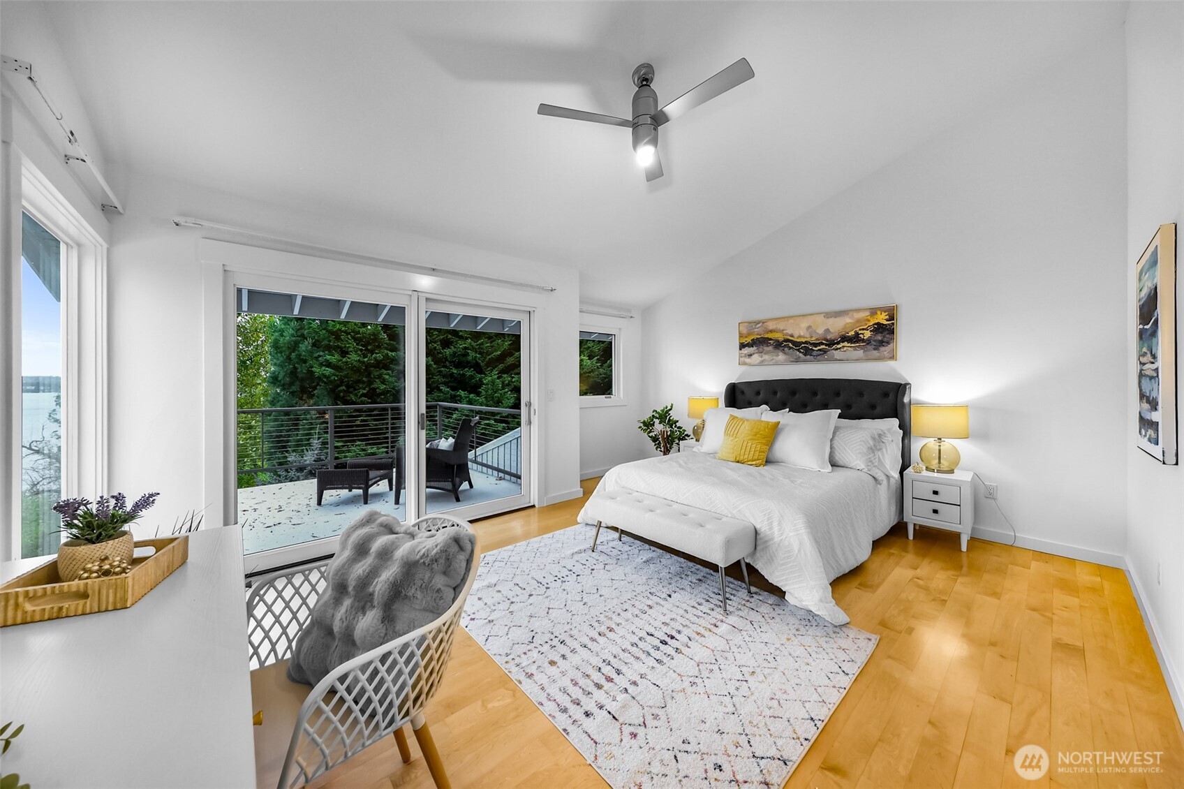 8449 West Mercer Way Mercer Island, WA 98040 - Photo 16 of 40 a spacious bedroom with a bed a couch and a large window