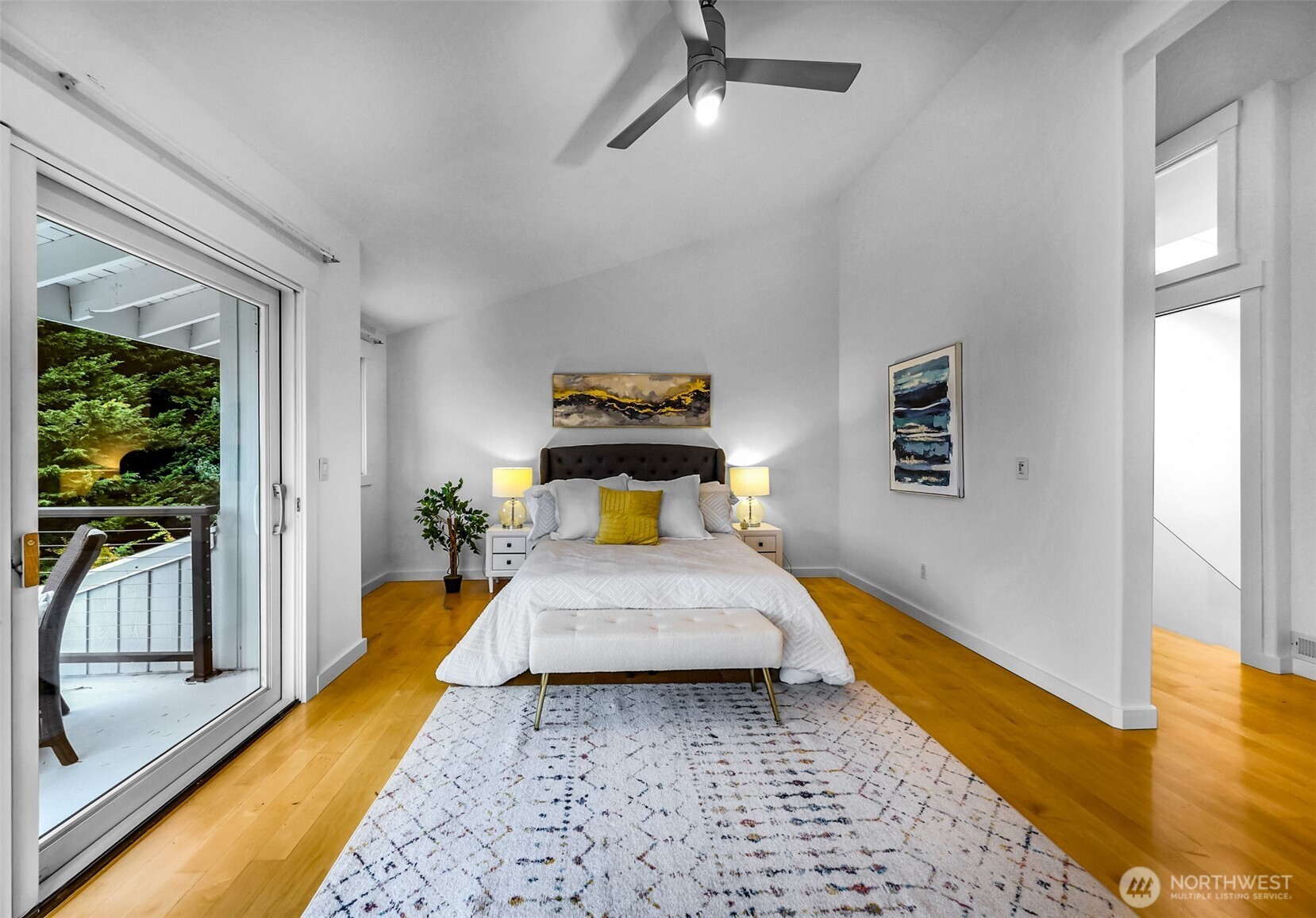 8449 West Mercer Way Mercer Island, WA 98040 - Photo 17 of 40 a bedroom with a bed and wooden floor